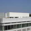 Turbine and generator cooling silencers and acoustic enclosures being installed at a co-generation plant