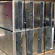 Group of galvanized rectangular duct silencers with flanged connections.